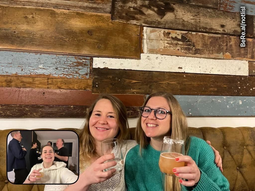 team mates smiling in an office after work event